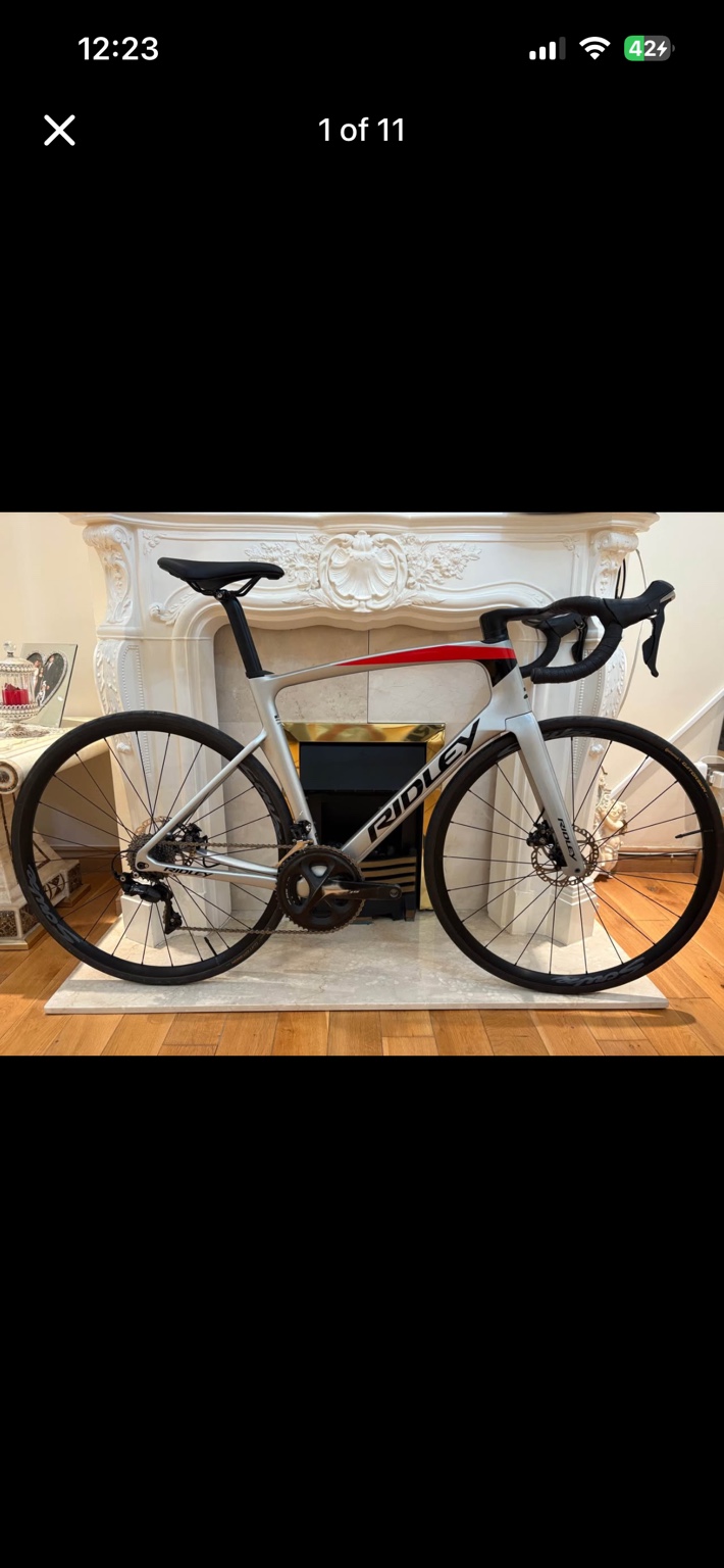 Grey and red Ridley Noah aero road bike, drive-side view